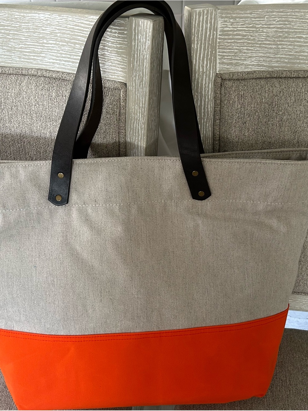 Sunbrella Neutral Canvas Tote with Bright Orange Base and brown Handles